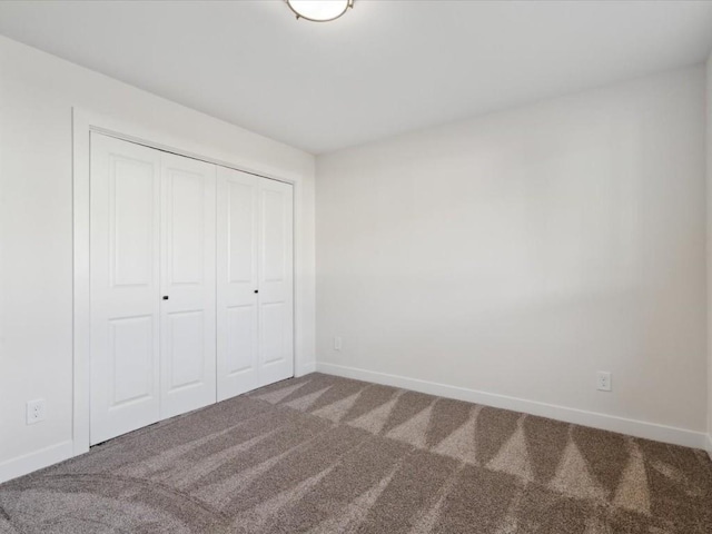 1501 Legend Dr, Tiffin, IA 52340 - unfurnished bedroom featuring carpet floors, baseboards, and a closet