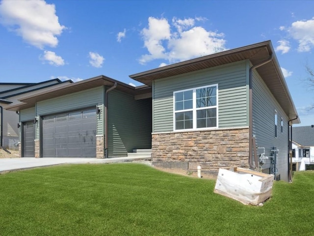 1501 Legend Dr, Tiffin, IA 52340 - view of front of home with an attached garage, stone siding, a front lawn, and driveway
