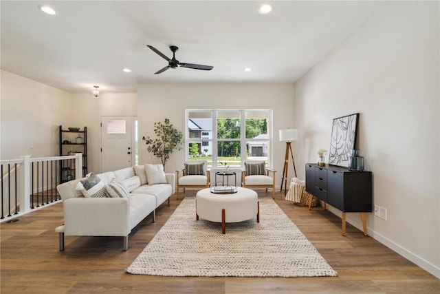 living room with hardwood / wood-style floors and ceiling fan