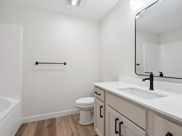314 Sierra Trce, Coralville, IA 52241 - bathroom featuring vanity, wood finished floors, and shower / washtub combination