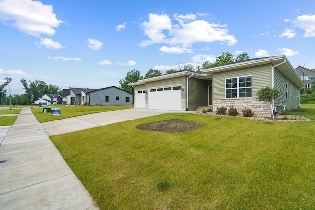 single story home featuring a garage and a front yard