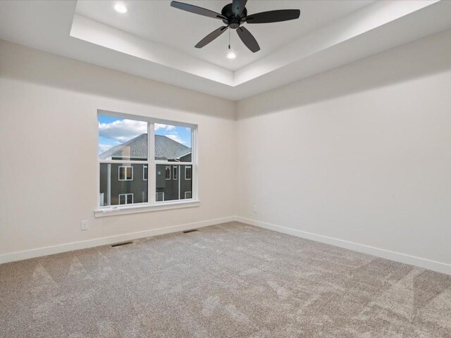 318 Sierra Trce, Coralville, IA 52241 - carpeted spare room featuring recessed lighting, a ceiling fan, and a tray ceiling