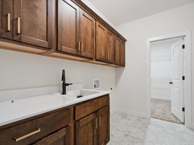 318 Sierra Trce, Coralville, IA 52241 - laundry area featuring hookup for an electric dryer, washer hookup, cabinet space, and light marble finish flooring