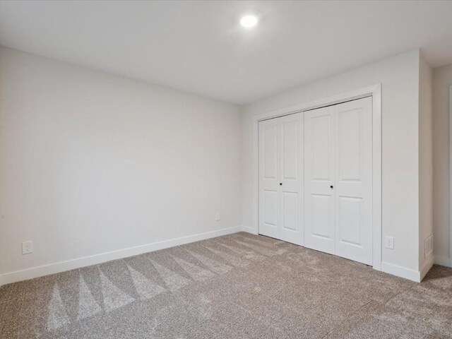 318 Sierra Trce, Coralville, IA 52241 - unfurnished bedroom featuring carpet floors, a closet, and recessed lighting