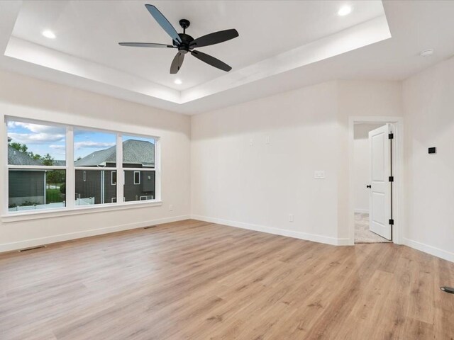 318 Sierra Trce, Coralville, IA 52241 - unfurnished room featuring a tray ceiling, light wood finished floors, recessed lighting, and a ceiling fan