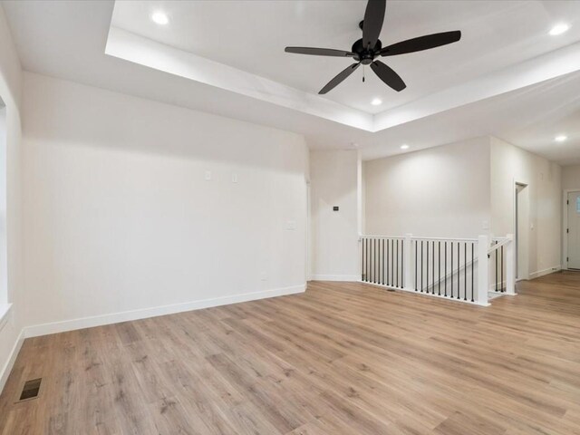318 Sierra Trce, Coralville, IA 52241 - unfurnished room with a raised ceiling, light wood-style floors, recessed lighting, and a ceiling fan