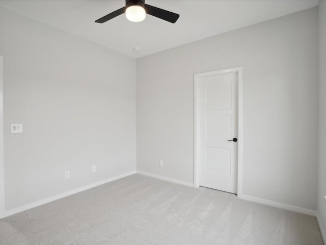 empty room with ceiling fan and light colored carpet