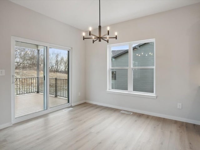 unfurnished dining area featuring light hardwood / wood-style flooring and a notable chandelier