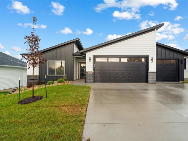 322 Sierra Trce, Coralville, IA 52241 - mid-century modern home featuring board and batten siding, concrete driveway, an attached garage, a front yard, and brick siding