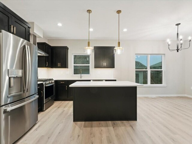 322 Sierra Trce, Coralville, IA 52241 - kitchen with stainless steel appliances, dark cabinetry, light wood-style flooring, and recessed lighting