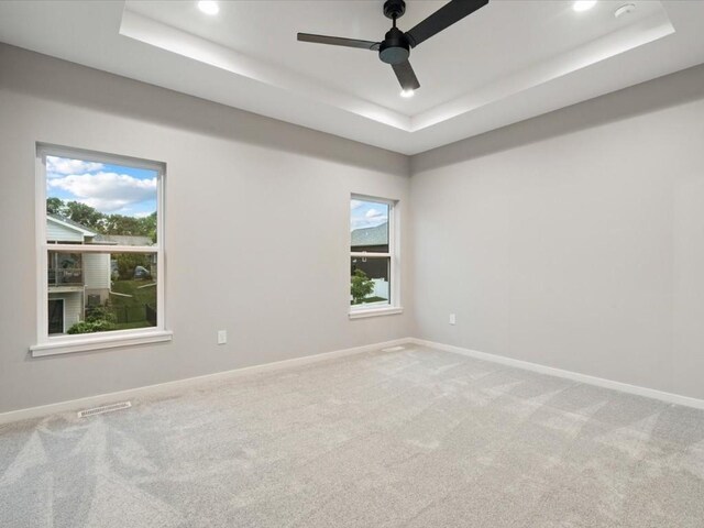 322 Sierra Trce, Coralville, IA 52241 - unfurnished room with a tray ceiling, plenty of natural light, recessed lighting, ceiling fan, and carpet