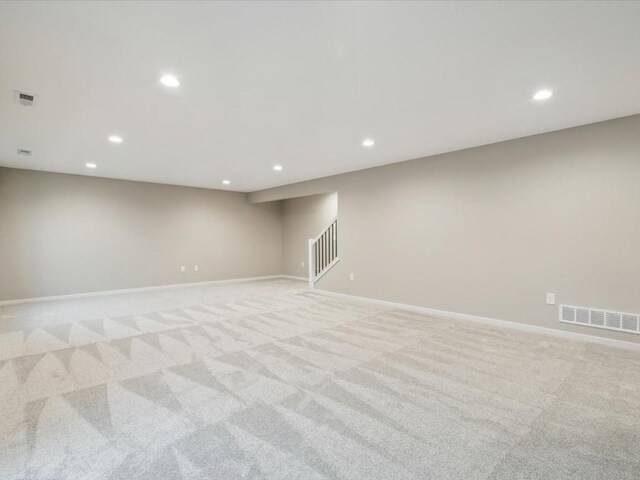 322 Sierra Trce, Coralville, IA 52241 - unfurnished room featuring recessed lighting, light carpet, and stairs