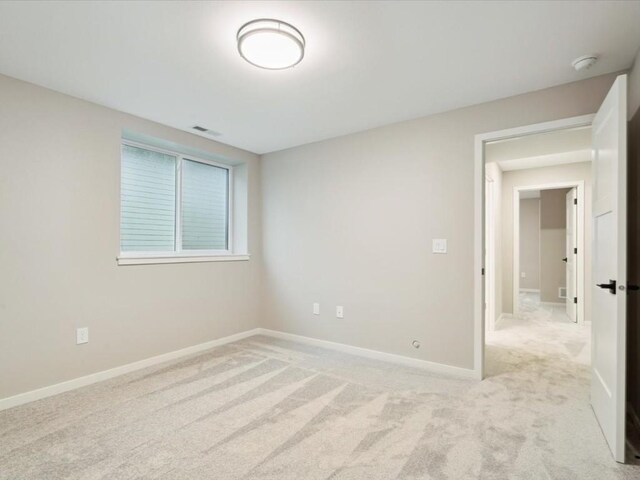 322 Sierra Trce, Coralville, IA 52241 - spare room featuring light carpet and a smoke detector