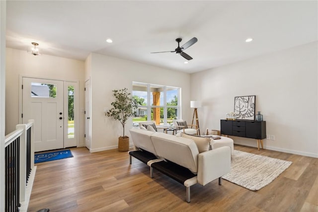 living room with ceiling fan and light wood-type flooring