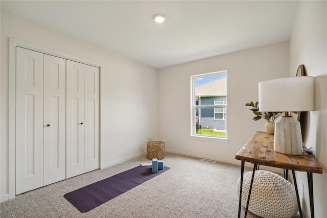 interior space featuring a closet and carpet