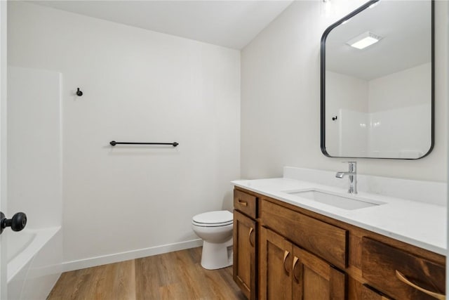 full bathroom featuring shower / tub combination, hardwood / wood-style floors, vanity, and toilet