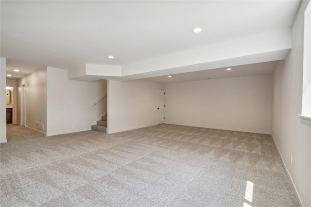 basement featuring light colored carpet