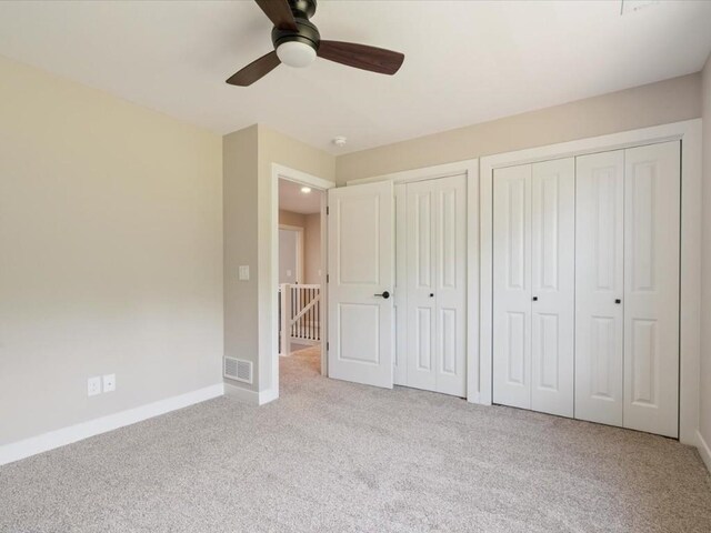 4648 Preston Ln, Iowa City, IA 52246 - unfurnished bedroom with two closets, carpet flooring, and ceiling fan