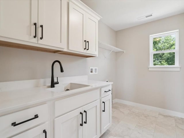 4648 Preston Ln, Iowa City, IA 52246 - washroom with washer hookup, cabinet space, and light marble finish floors