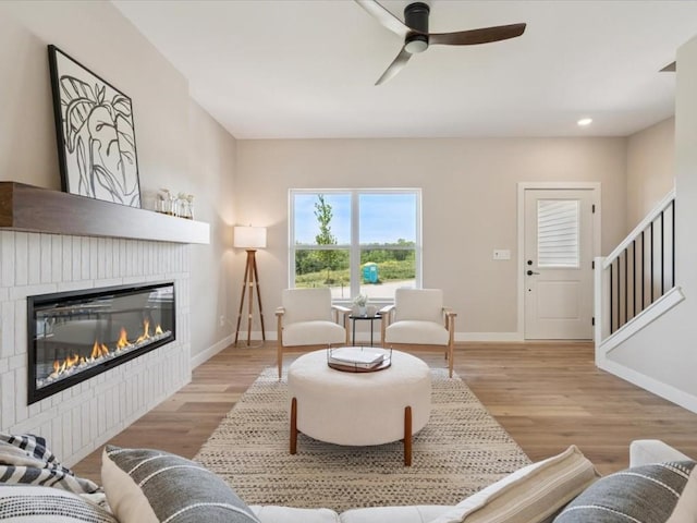 4648 Preston Ln, Iowa City, IA 52246 - living room featuring a glass covered fireplace, ceiling fan, wood finished floors, stairs, and recessed lighting