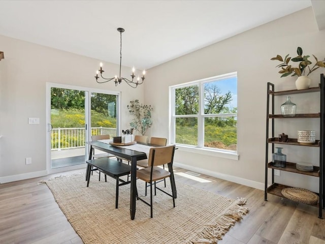 4648 Preston Ln, Iowa City, IA 52246 - dining area with a chandelier and light wood-style flooring