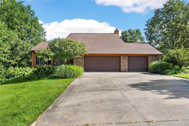 view of front of property with a front yard and a garage