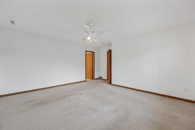 empty room with ceiling fan and light colored carpet