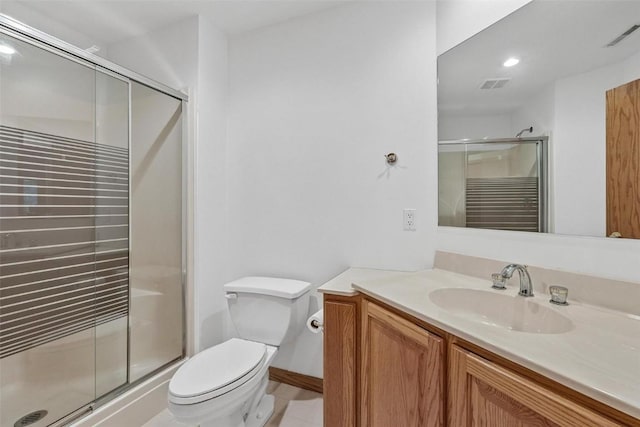 bathroom with vanity, an enclosed shower, and toilet