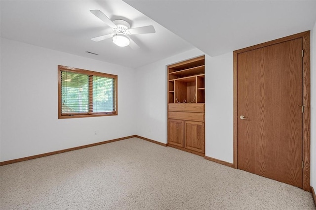 unfurnished bedroom with ceiling fan and light colored carpet