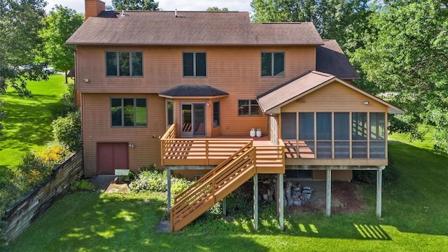 back of house with a sunroom, a deck, and a lawn