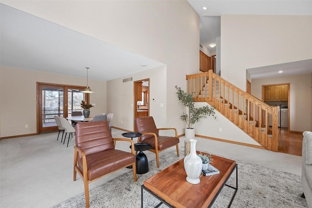 carpeted living room featuring a high ceiling