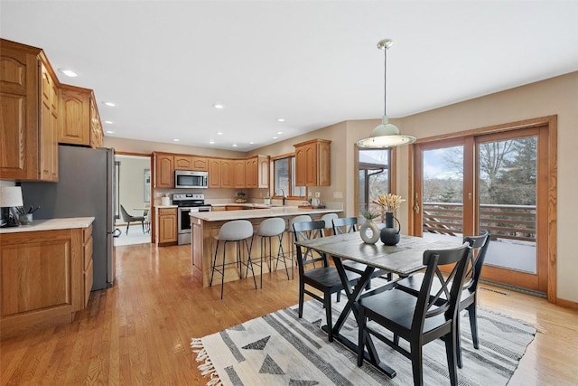 dining room with light hardwood / wood-style flooring and sink