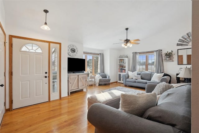 living room featuring a wealth of natural light, light wood-type flooring, and ceiling fan