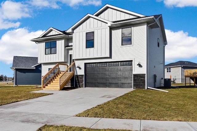 view of front of home with a front yard, a garage, and central AC unit