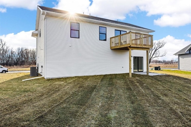 rear view of property with a lawn, a balcony, and central AC unit