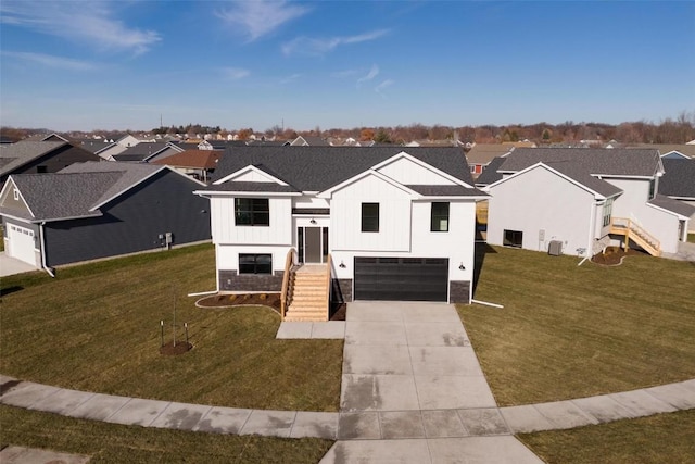 view of front of property featuring a garage, a front lawn, and cooling unit