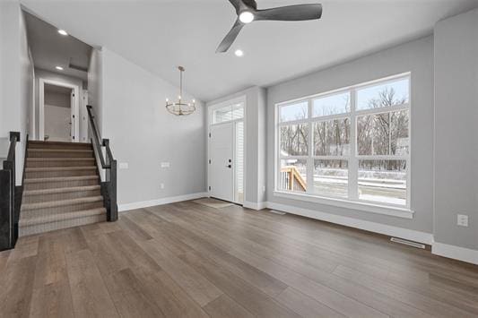 entrance foyer featuring wood-type flooring and ceiling fan with notable chandelier