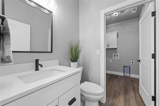 bathroom featuring vanity, wood-type flooring, and toilet