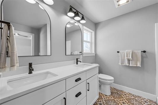 bathroom with tile patterned floors, vanity, and toilet