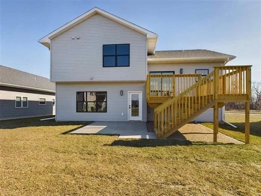 back of property with a patio area, a yard, and a wooden deck