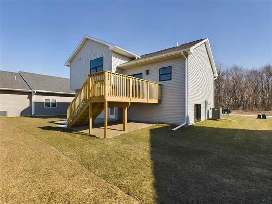 back of house featuring a yard, cooling unit, and a deck