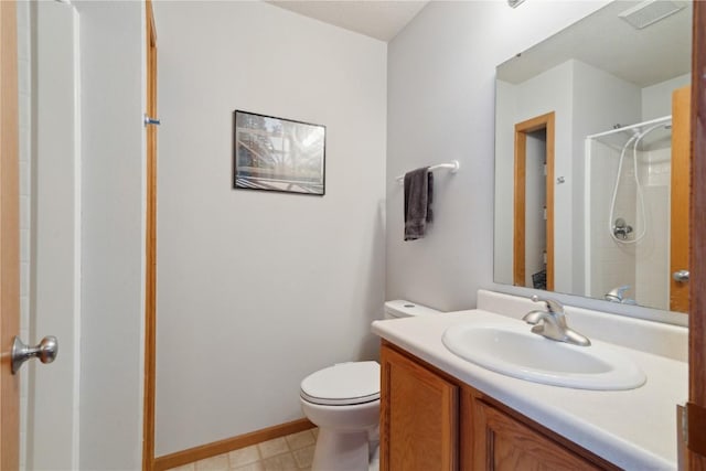 bathroom with vanity, toilet, and walk in shower