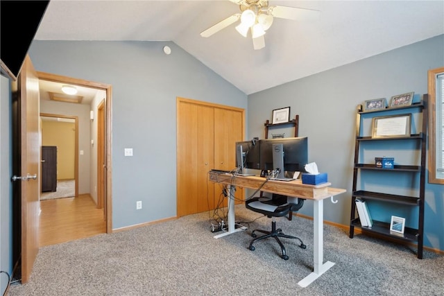 home office featuring ceiling fan, light carpet, and vaulted ceiling