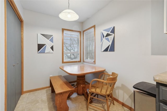 dining area with light tile patterned floors