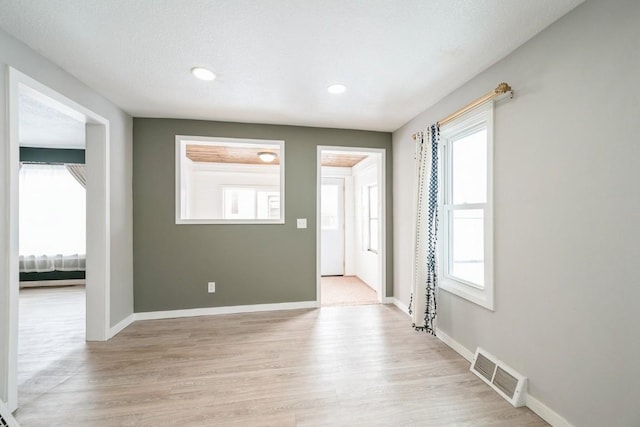 foyer with plenty of natural light and light hardwood / wood-style floors