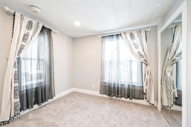 empty room featuring light colored carpet