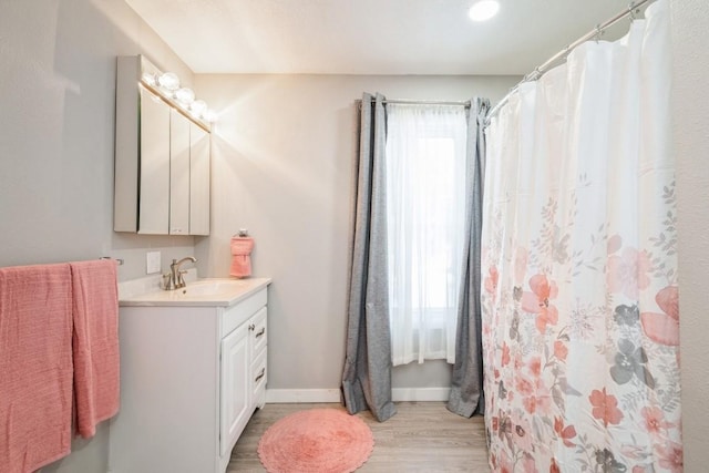 bathroom with vanity and hardwood / wood-style floors