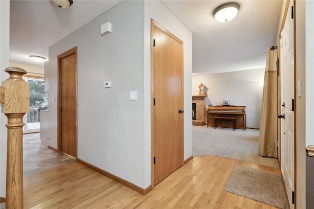 corridor with light wood-type flooring