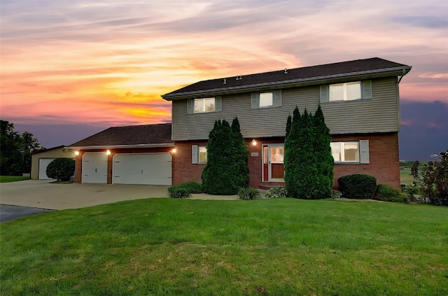 view of front of home featuring a garage and a yard