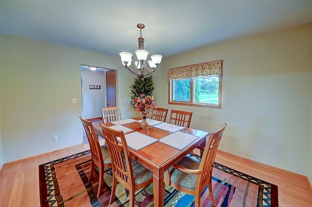 dining room with a notable chandelier and hardwood / wood-style floors